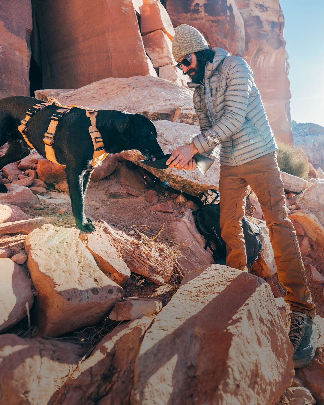 Man giving water to his dog with the Slurpy Sack