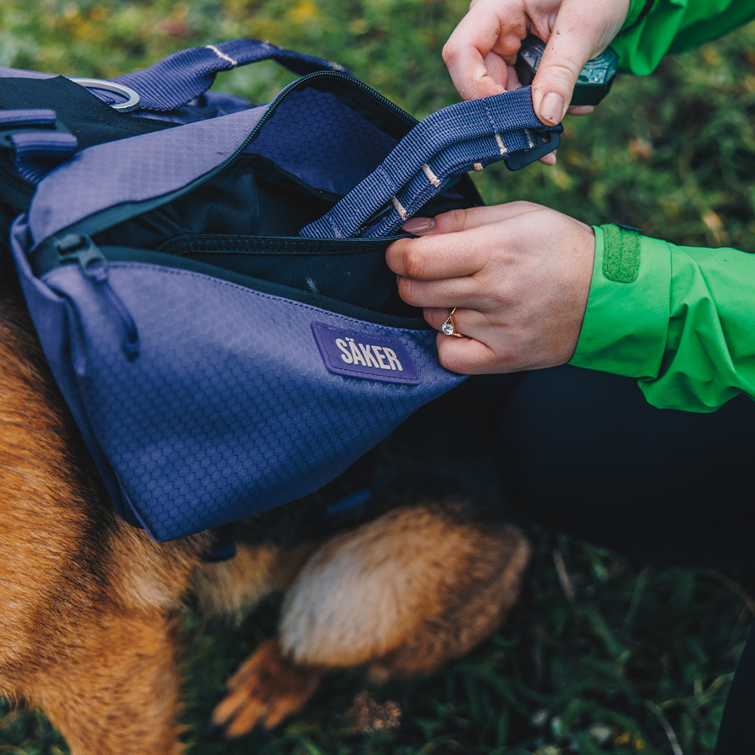 Woman inserting canyon collar in the pouches of the Canyon Light Pack