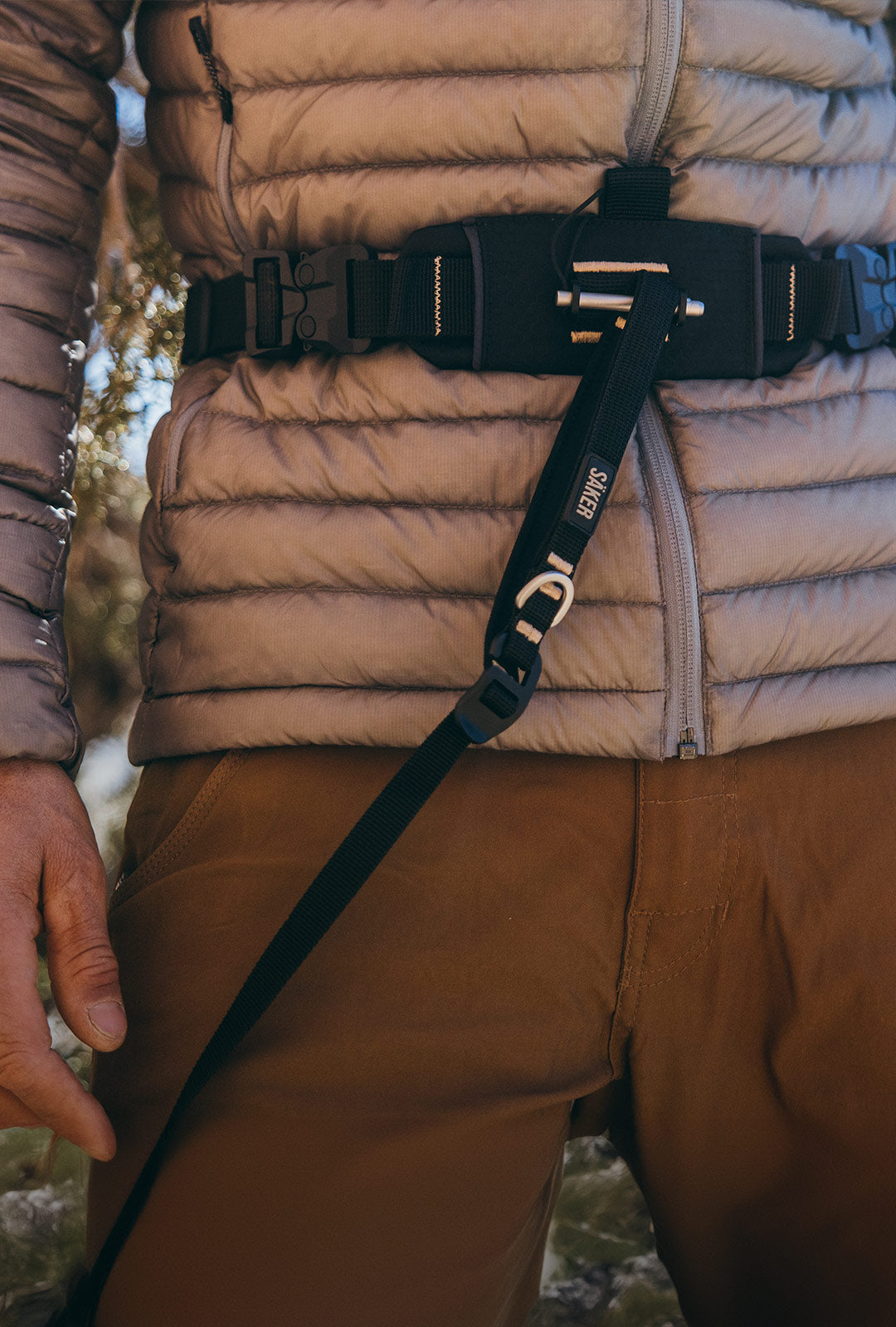 Close view of man wrapping the extension of the Canyon light harness around his waist