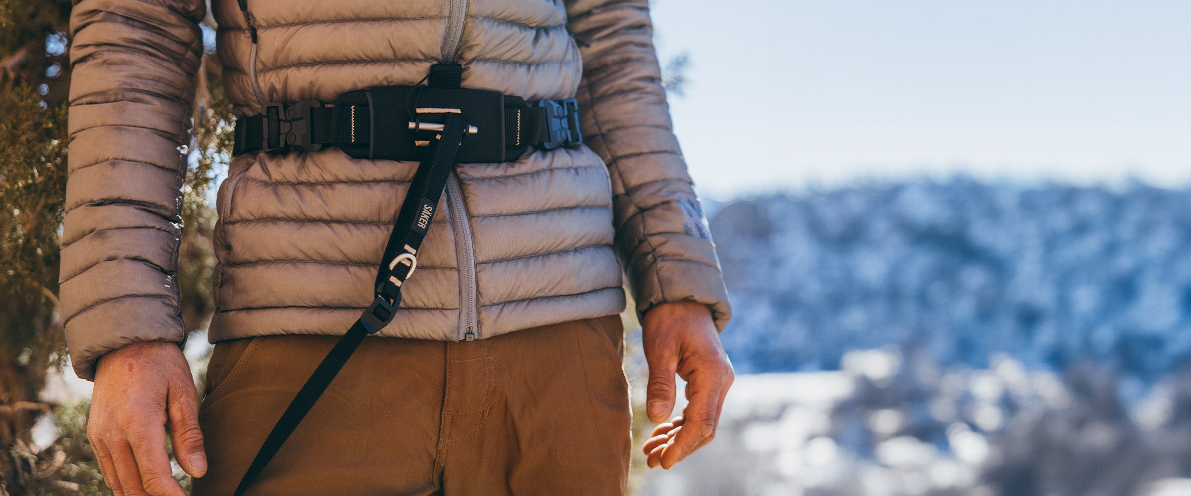 Close view of man wrapping the extension of the Canyon light harness around his waist